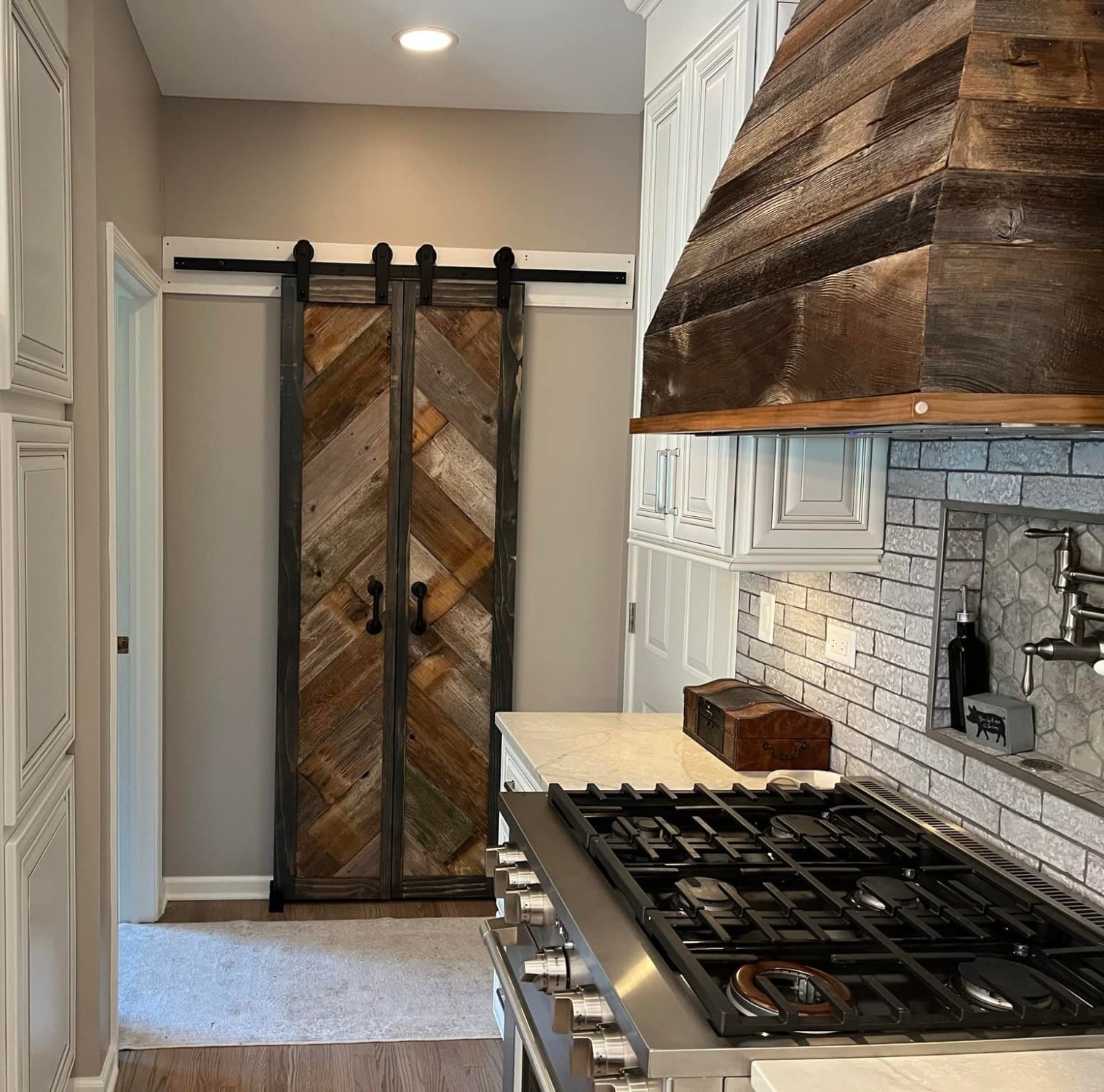 Custom reclaimed wood barn doors and range hood – Private Residence