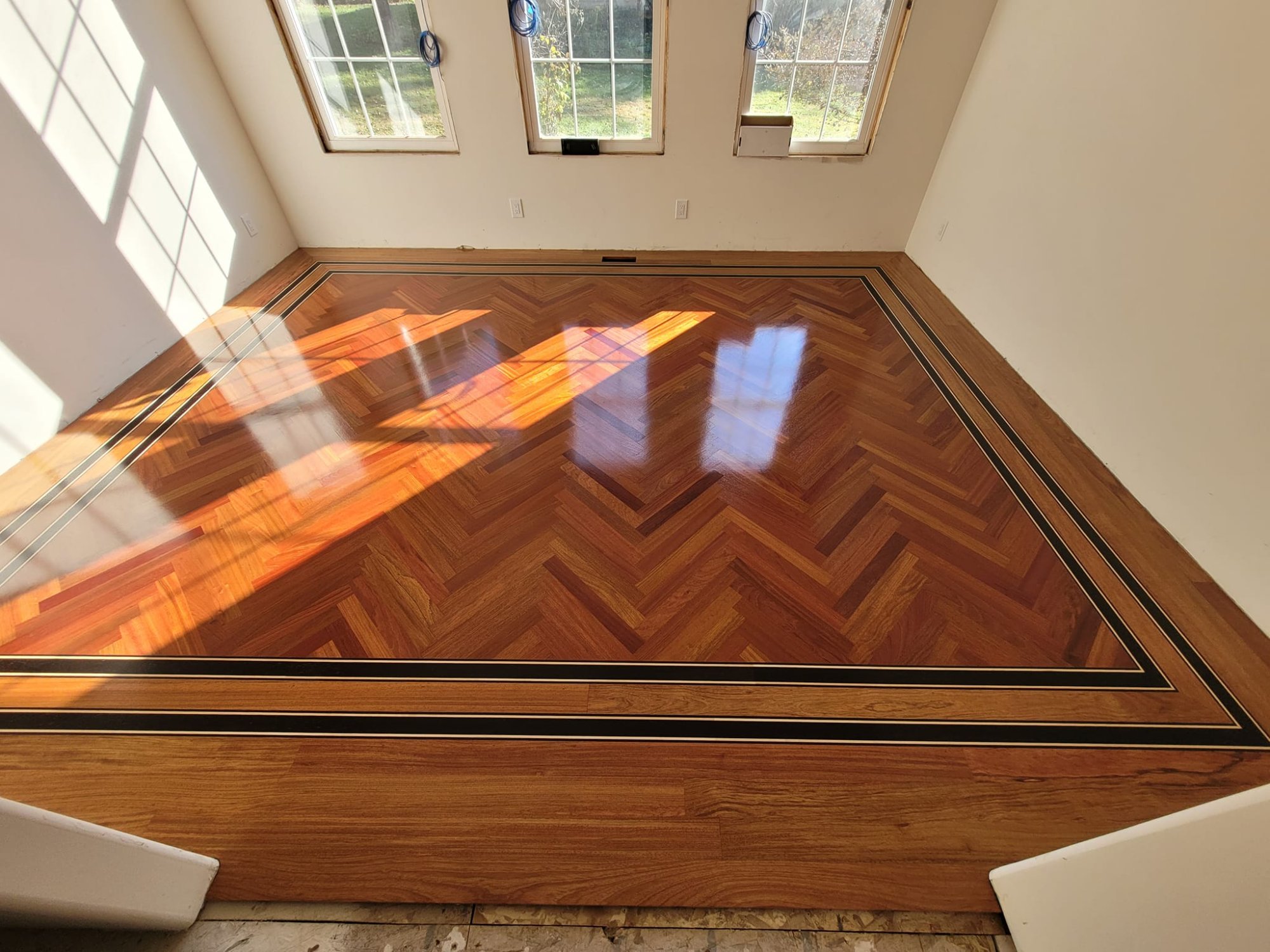 Custom hardwood parquet floor inlay with ebony border